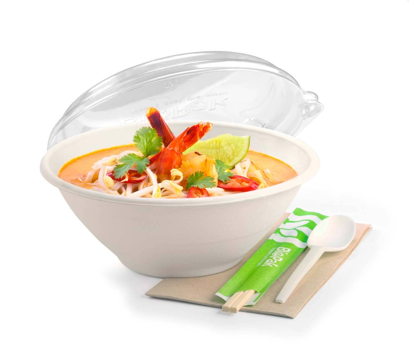 A bowl of shrimp noodle soup garnished with cilantro and lime, served in a White Plant Fibre BioBowl, accompanied by a spoon, chopsticks, and a napkin on the side.
