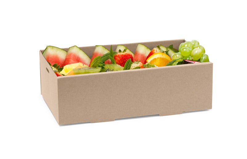 A BioBoard Catering Tray base holds a cardboard box filled with assorted sliced fruits, including watermelon, kiwi, orange, strawberry, pineapple, and green grapes.