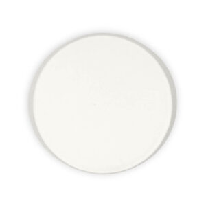 A white, round ceramic plate viewed from above on a plain background, accompanied by a neatly placed paper sauce cup.