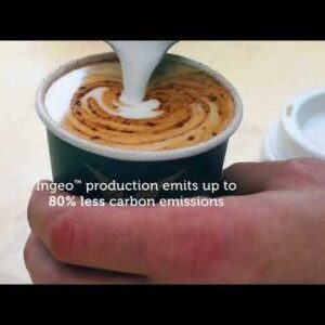 A hand holds a 350ml BioCup of coffee with latte art as milk is poured; text reads "Ingeo™ production emits up to 80% less carbon emissions.