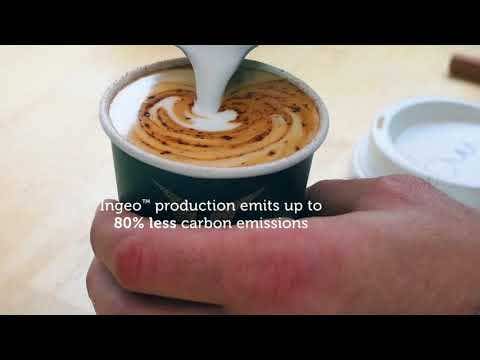 A hand pours steamed milk into a 350ml BioCup of coffee, creating latte art. Text on image reads: โIngeoโข production emits up to 80% less carbon emissions.โ.