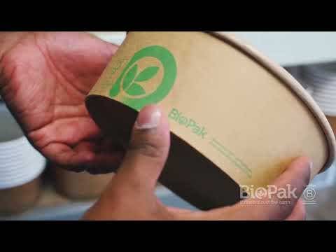 A person holds a brown Large Kraft BioBowl compostable food container with a green leaf logo and the brand name "BioPak" printed on the side.